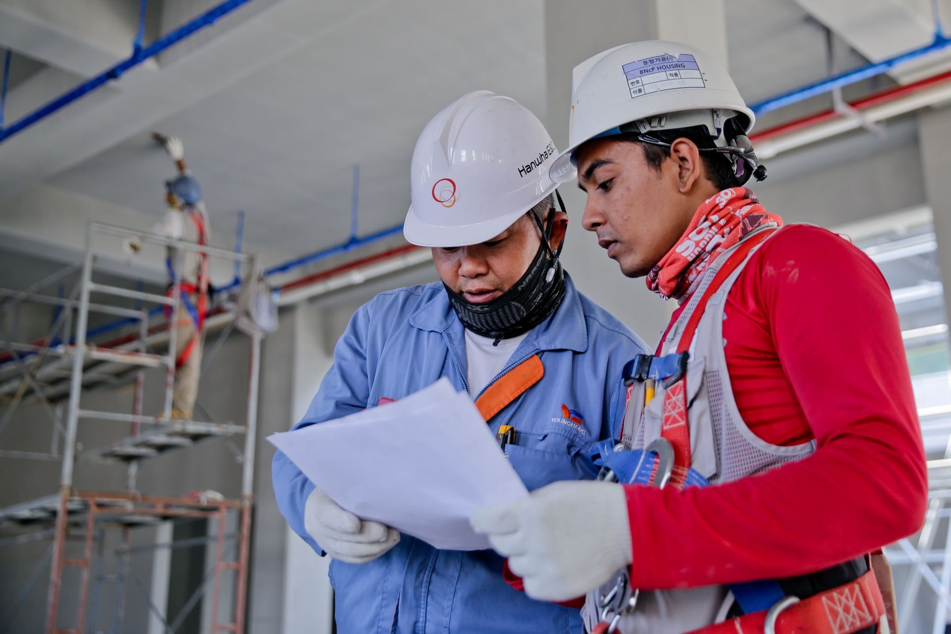 Construction professionals reviewing project plans together on an active job site