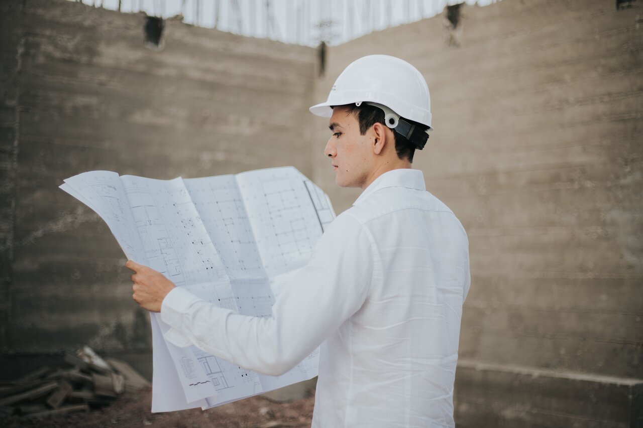 A project manager reviewing construction plans and documentation in detail